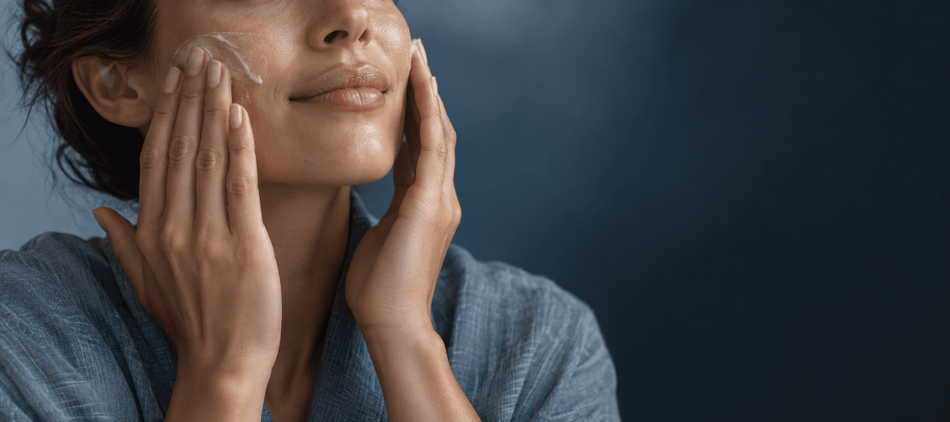 An anonymous person pressing moisturizer into naturally textured skin